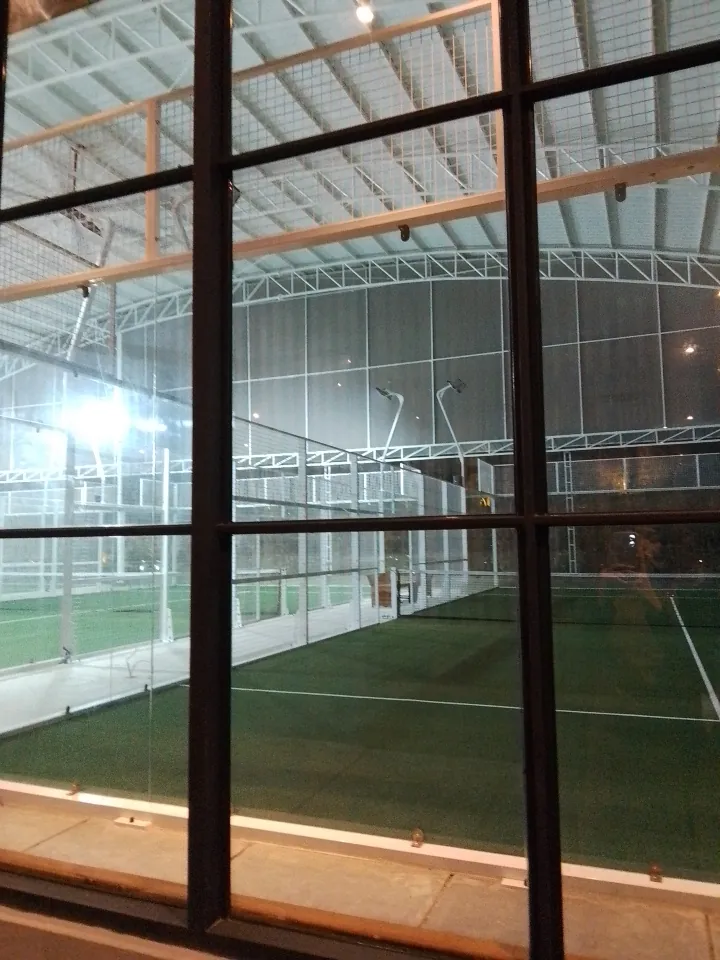 Ella's courts seen through the café's tall black-framed windows
